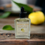 Japanese Bath Body Hair Oil sitting on wooden table with yuzu fruit in background