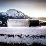 Iceland Perfume Oil laying on snowy table with Iceland in background