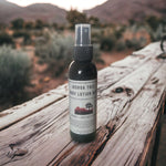 Joshua Tree Body Lotion Mist on wooden table with desert imagery in background