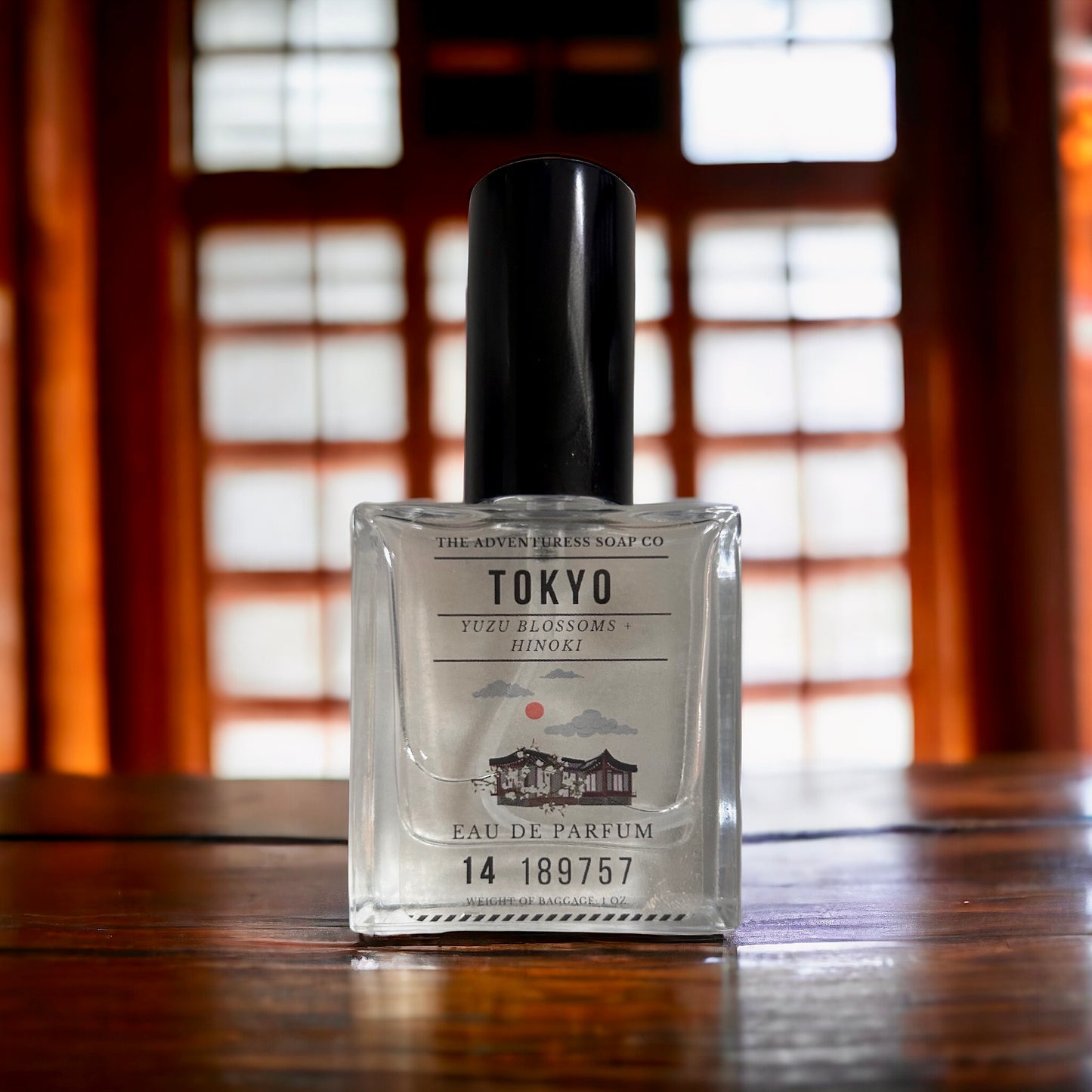 Tokyo Eau de Parfum on wooden table with wooden doors in background.