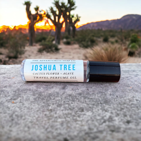 Joshua Tree Perfume Oil ith cactus flower and agave with joshua trees in background