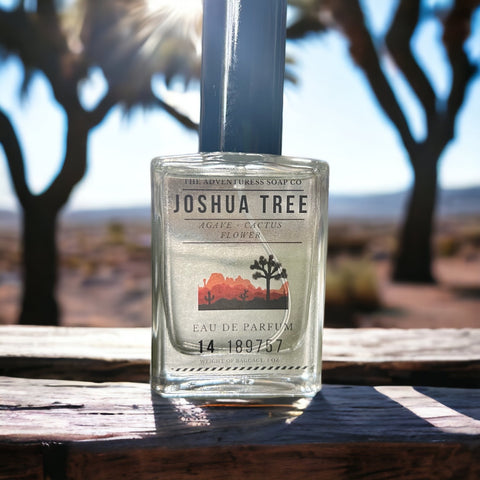 Joshua Tree Eau de Parfum sitting on wooden table with joshua trees in background