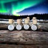 Fjord Breeze, Northern Lights, Iceland, Snowfall Car Diffusers on wooden table with Northern Lights in background