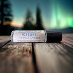 Iceland Perfume Oil laying on table with northern lights in backdrop