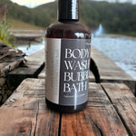 Hot Spring Body Wash and Bubble Bath sitting on wooden deck with hot spring in background