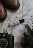 Adventuress Perfume Oil on a background with a map. 