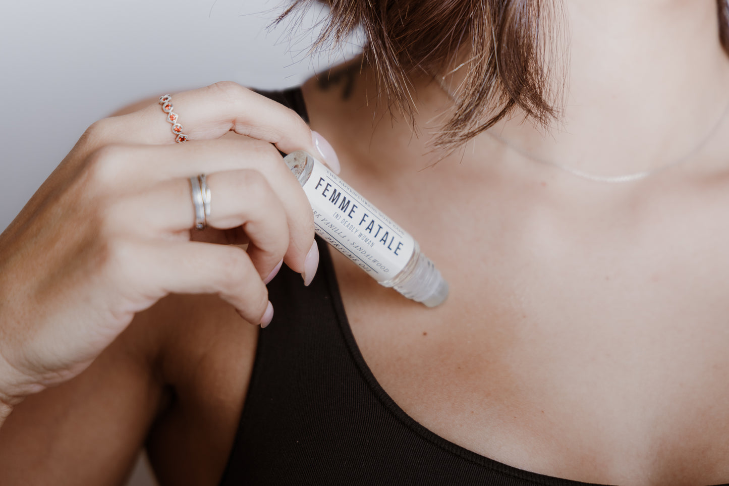 Femme Fatale Perfume Oil being applied by woman to neck