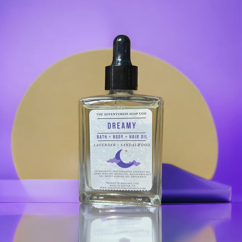 Dreamy Bath Body Hair Oil Bottle standing in front of purple background
