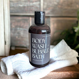 Hot Spring Body Wash and Bubble Bath sitting on white towel in cabin bathroom