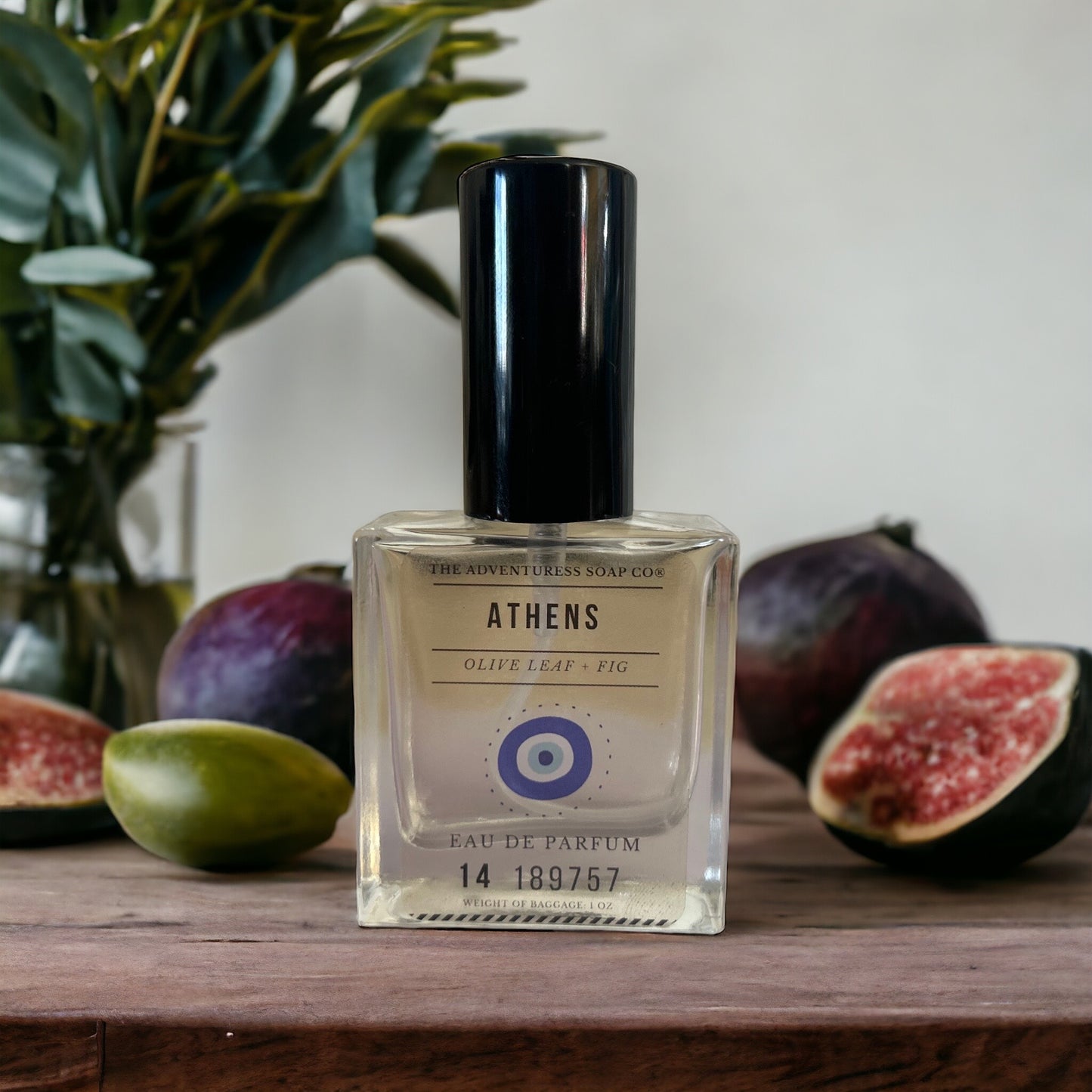 Athens Eau de Parfum with olive leaf and fig in background.