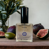 Athens Eau de Parfum with olive leaf and fig in background. 