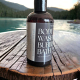 Hot Spring Body Wash and Bubble Bath sitting on deck with hot spring in background