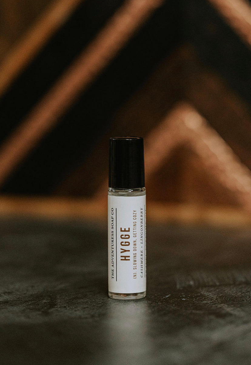 hygge perfume oil on wooden backdrop