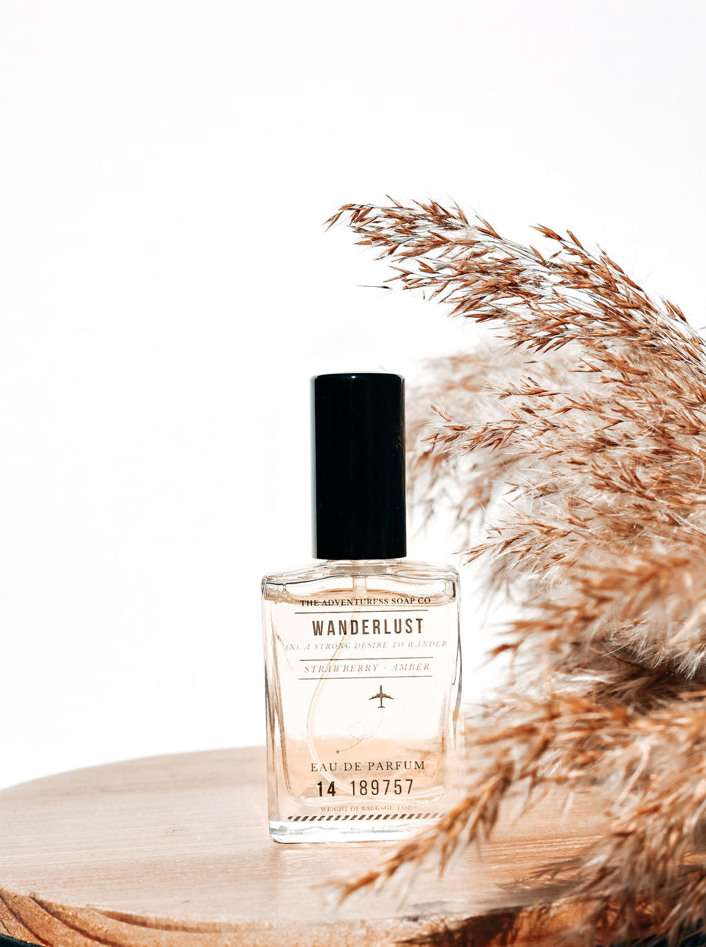 wanderlust eau de parfum displayed on a wooden backdrop