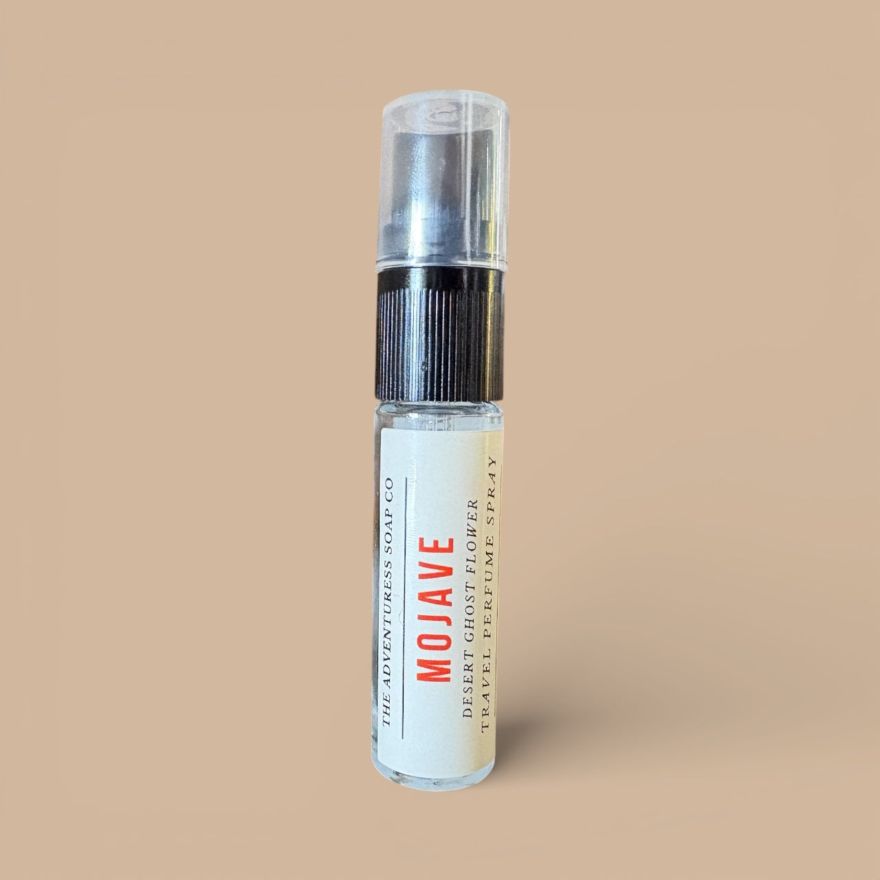 Clear spray bottle labeled 'Mojave' on a beige background