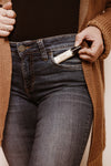 Hygge Perfume Oil being placed in pocket by woman 