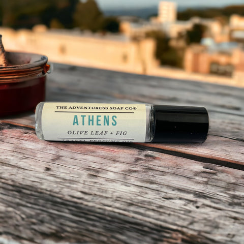 Athens Perfume Oil on a wooden table with Athens in background.