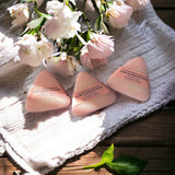 Cherry Blossom Mountain Soap laying on towel with pink flowers in backdrop