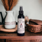 Hygge Lotion Mist laying on dresser with cozy accents