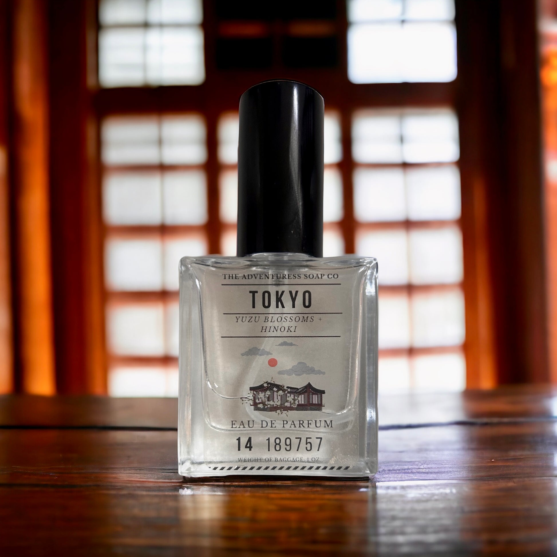 Tokyo Eau de Parfum on wooden table with wooden doors in background.