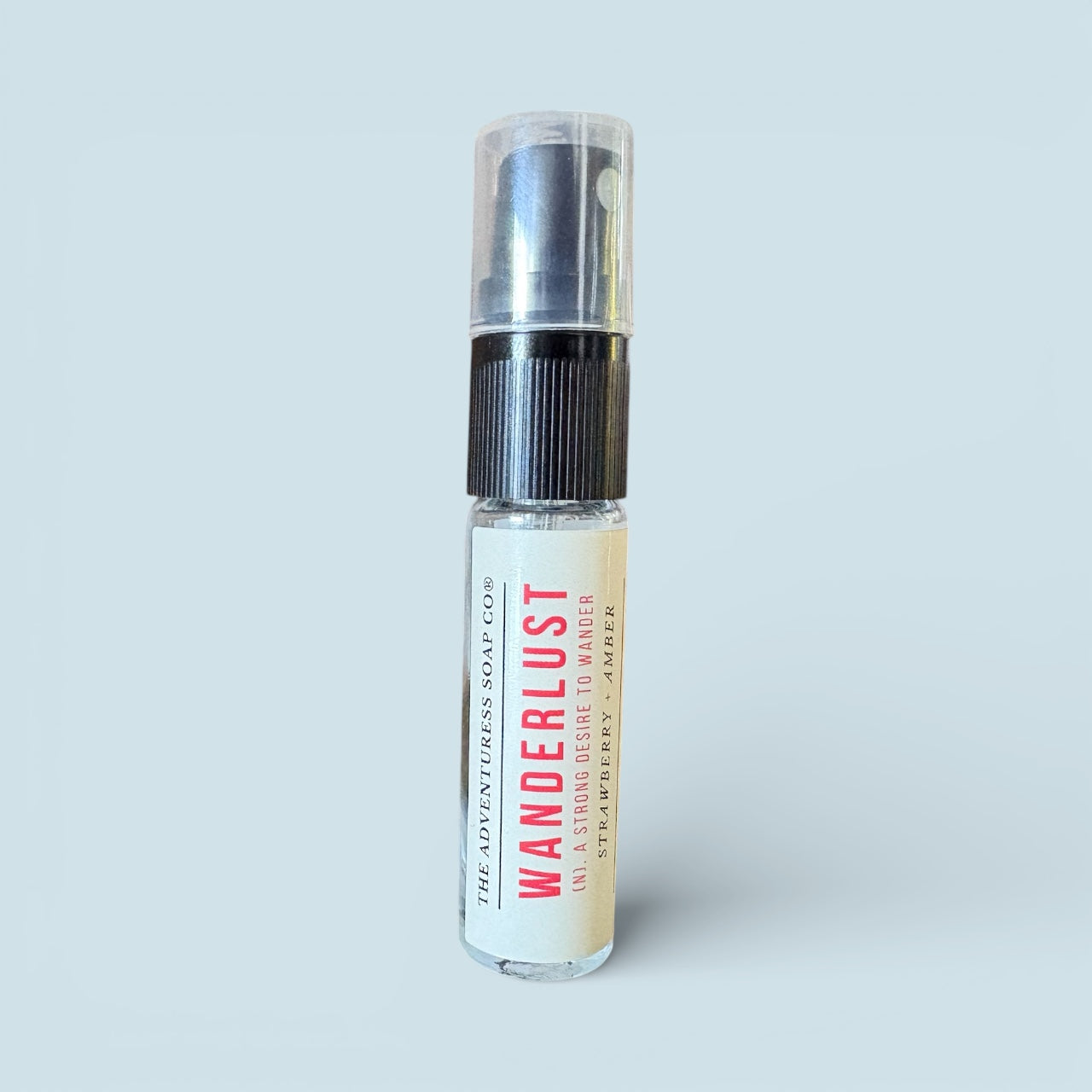 Spray bottle labeled 'Wanderlust' on a light gray background