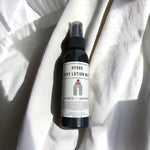 Hygge Lotion Mist laying on cozy sheet