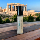 Athens Perfume Oil on wooden table with Acropolis in background.