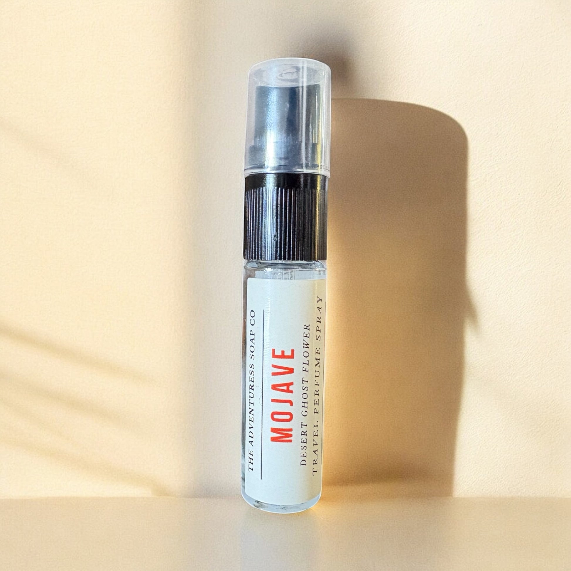 Small spray bottle labeled 'Mojave' on a beige background