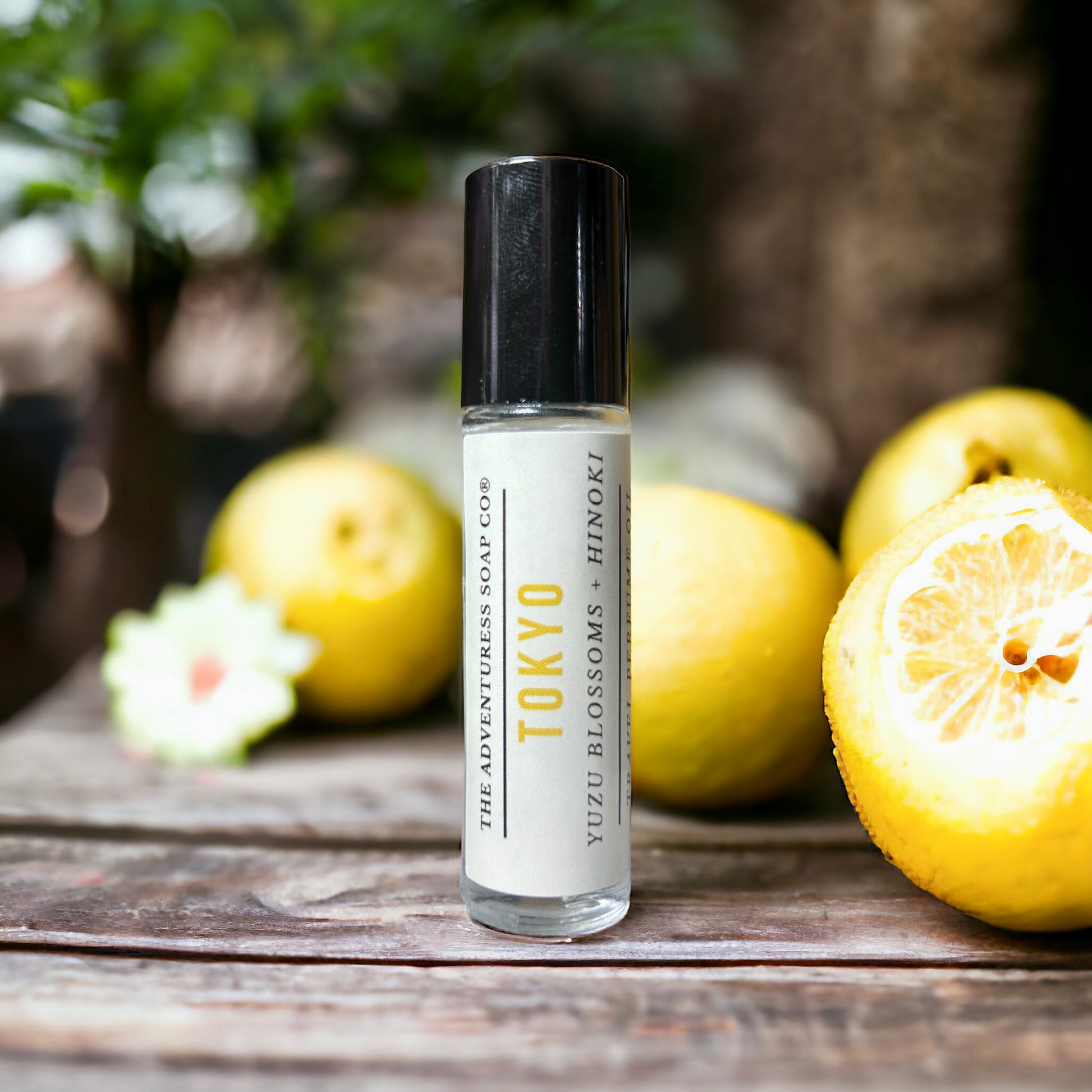 Tokyo Perfume Oil on wooden table with yuzu in background