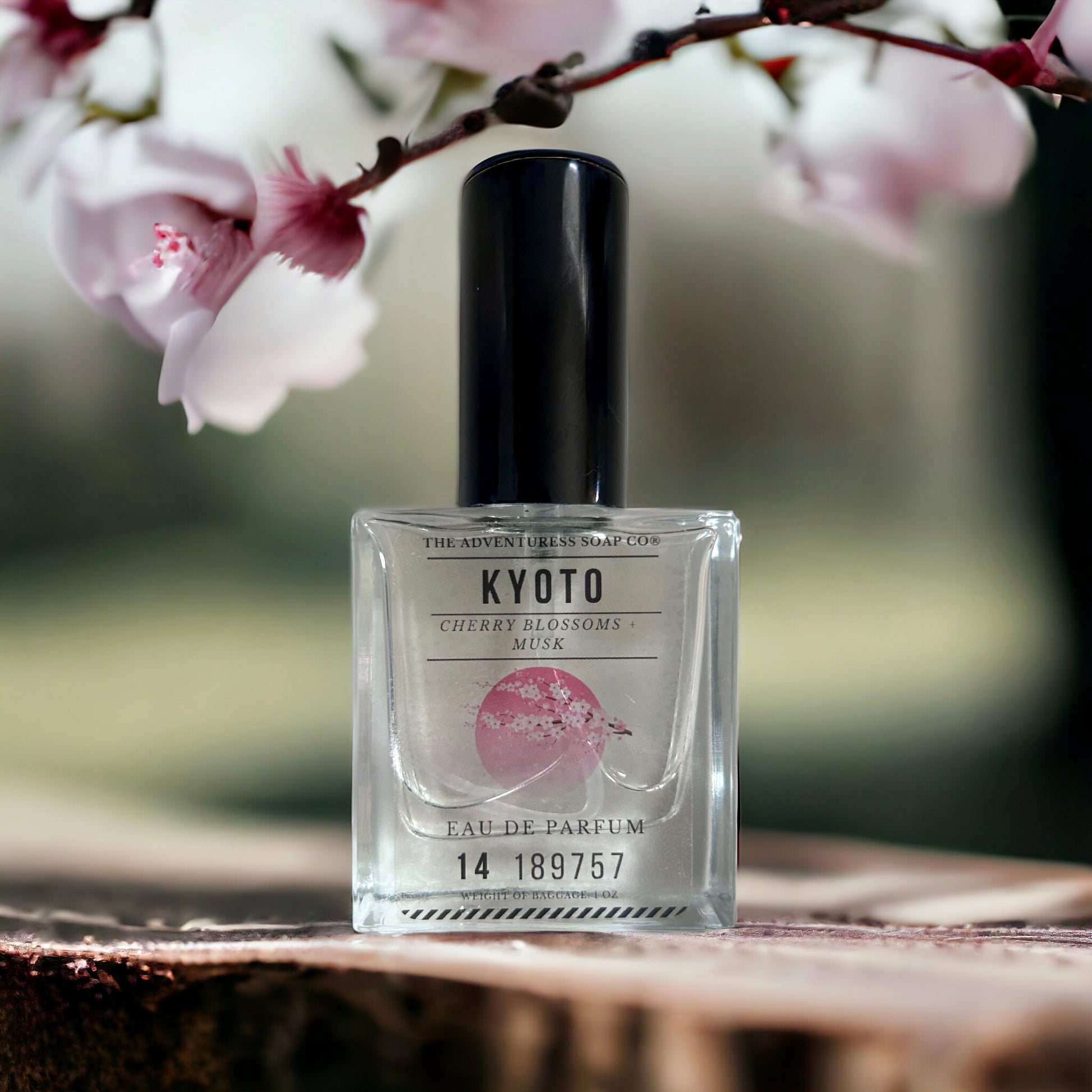 Kyoto Eau de Parfum sitting on wooden table with cherry blossoms in background