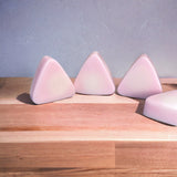 Small pink mountain soaps on wooden table
