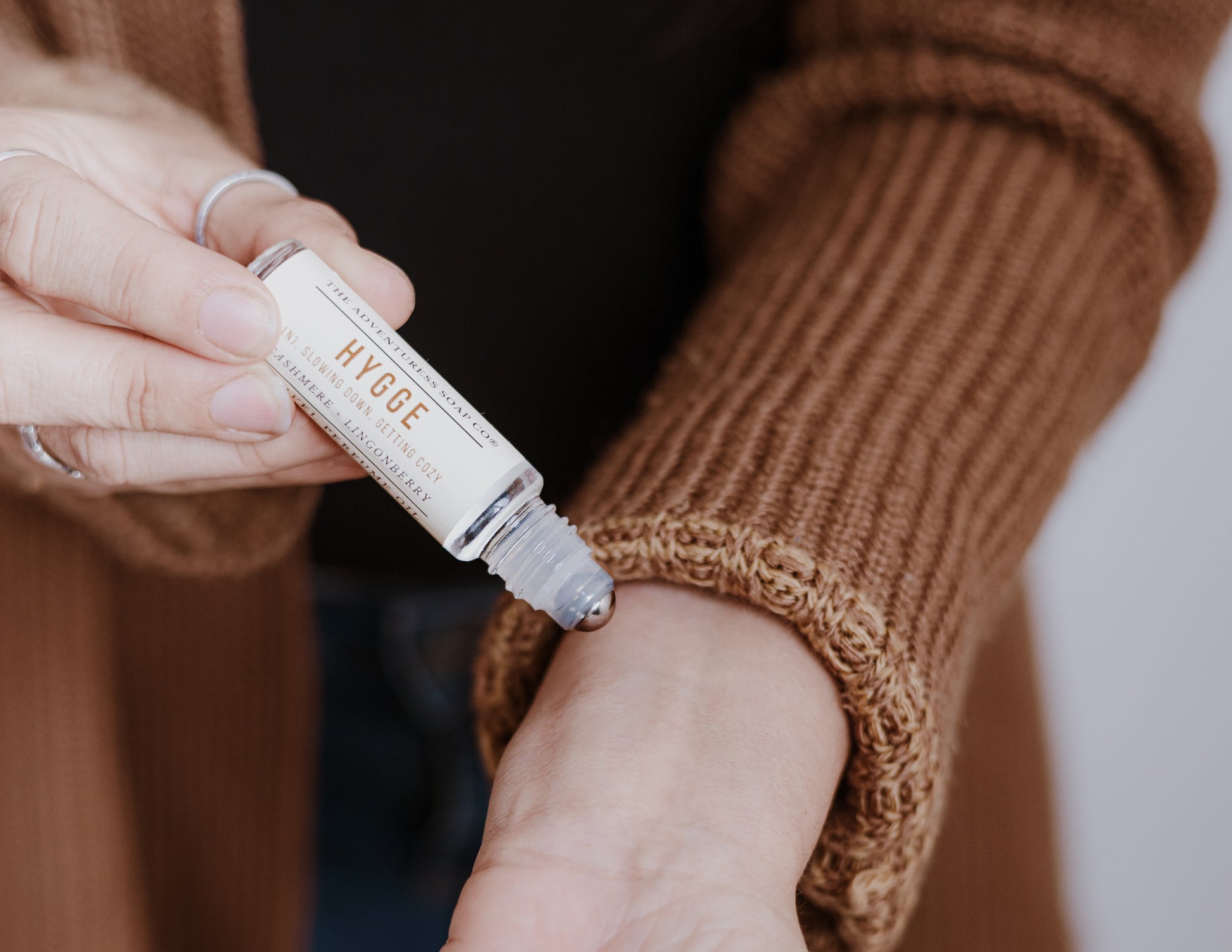 Hygge Perfume Oil being applied by woman to wrist 