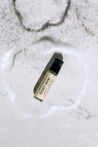 secret agent perfume oil on a white backdrop