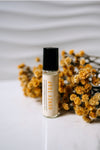 honey trap perfume displayed on white background with yellow flowers 