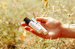 rocky mountains travel perfume oil being held by woman in mountain meadow