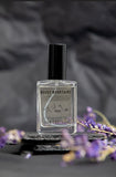 Rocky Mountains perfume with dark background and purple wildflowers in background