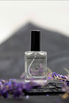 Rocky Mountains perfume displayed on dark backdrop with purple wildflowers in background